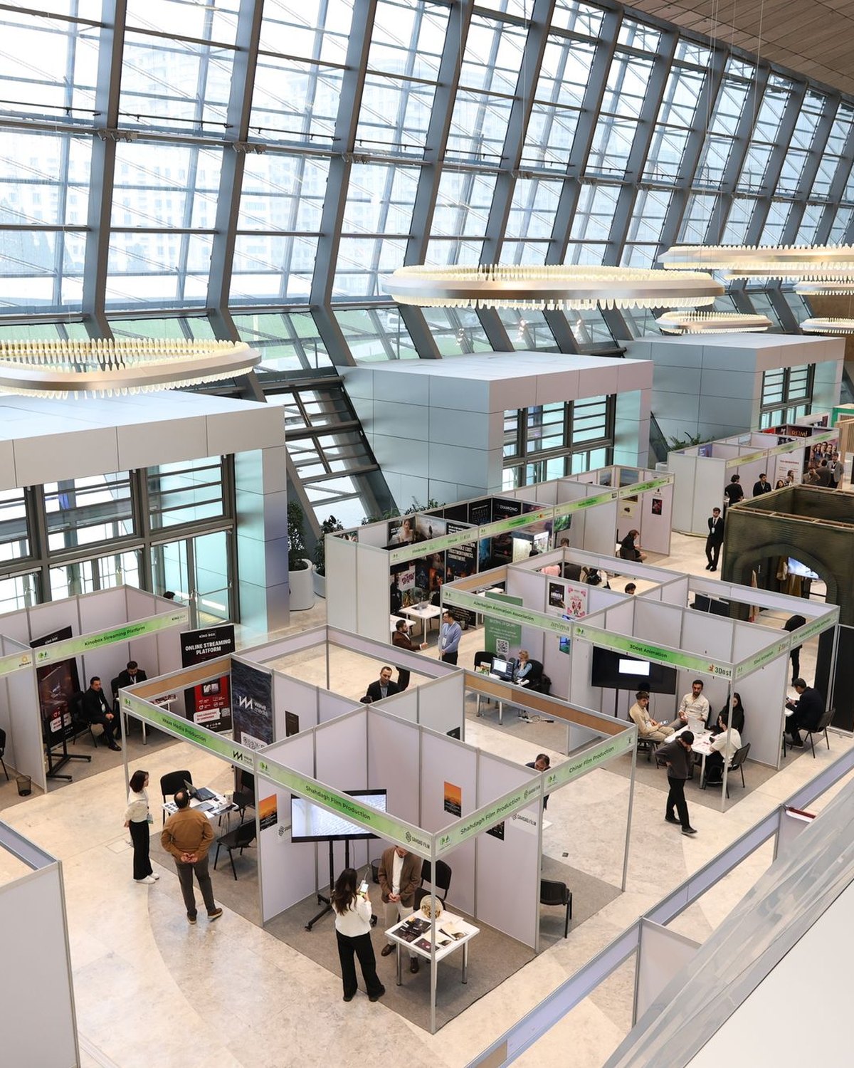 A busy trade show hall with visitors at the stands